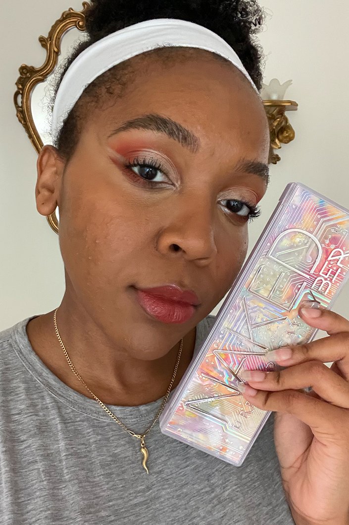 person wearing red and metallic eyeshadow