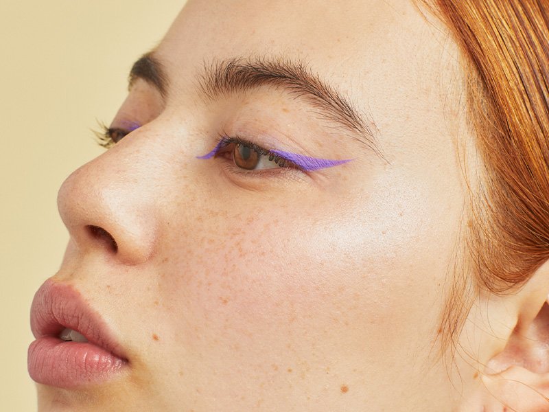 person wearing pastel purple winged eyeliner