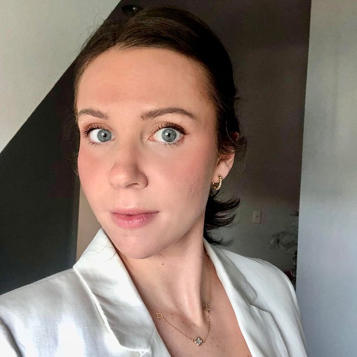 person wearing natural makeup with rosy cheeks