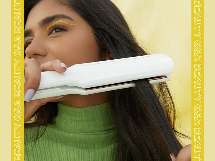 Person using a flat iron on their hair