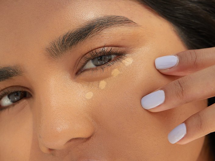 close-up of person's face with concealer swatches under eye