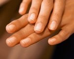 hands with nails wearing sheer nail polish