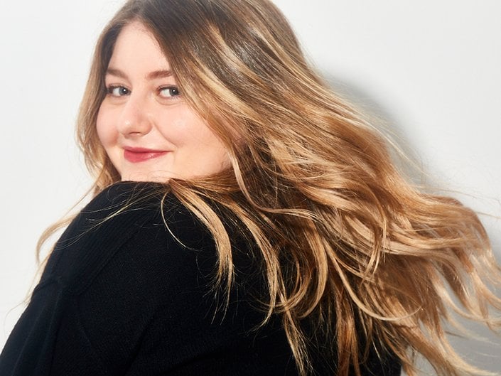 person smiling and looking over shoulder