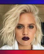 Picture of a platinum blonde model with smoky eyes and dark lipstick on red and purple gradient graphic background