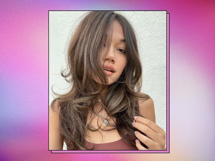 person with brown hair on graphic background