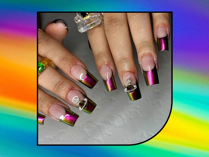 person holding out their hands with green and pink chrome french nail art