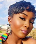 person with dark skin with a pixie haircut