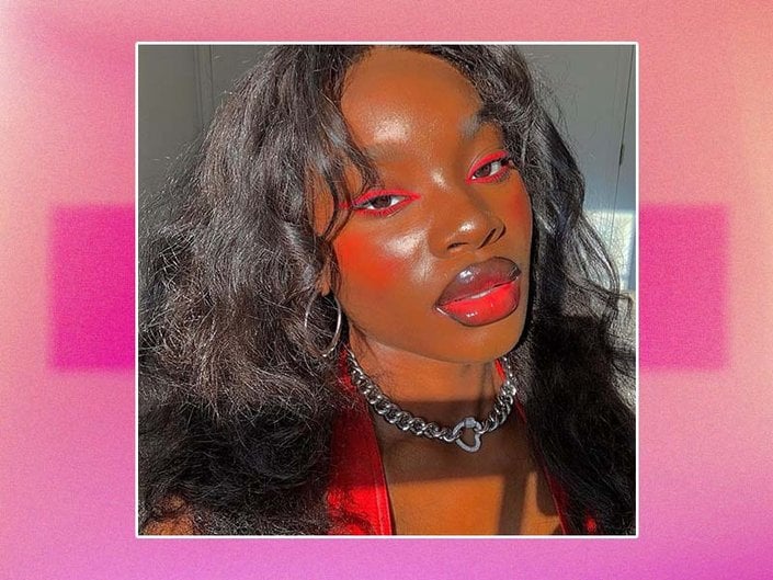 person wearing red eyeliner, blush, and lipstick