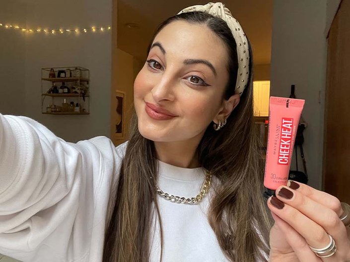 A person holding the Maybelline New York Cheek Heat Gel-Cream Blush in Coral Ember