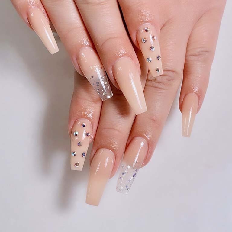 hands with nude nails with rhinestones