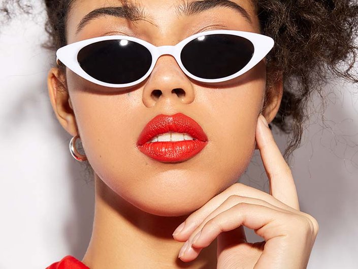 person wearing white sunglasses and red lipstick