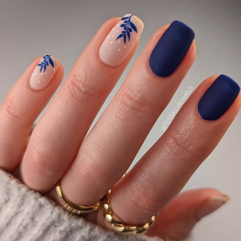 hands with navy blue nails and nail art