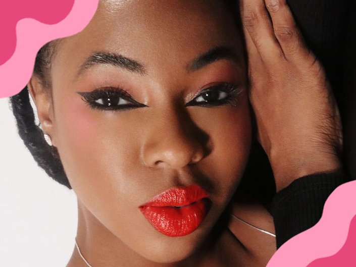 person wearing winged eyeliner and red lipstick
