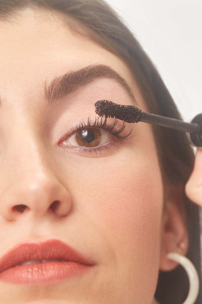 Person applying mascara