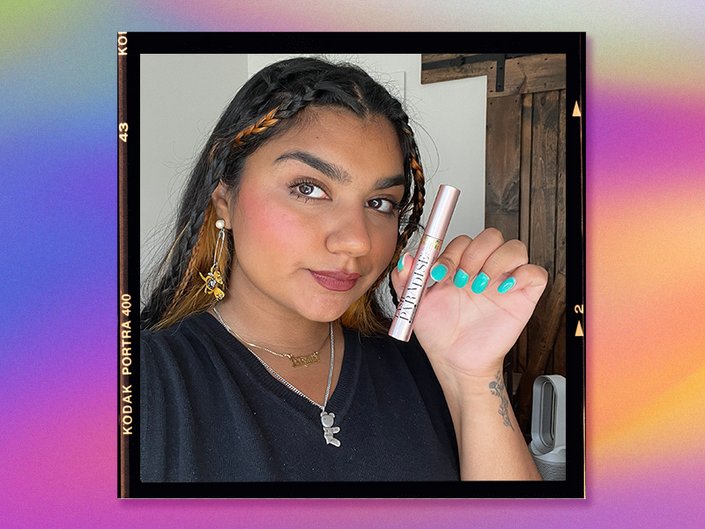 Person holding mascara tube