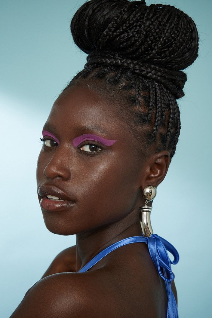 Person wearing box braids in topknots