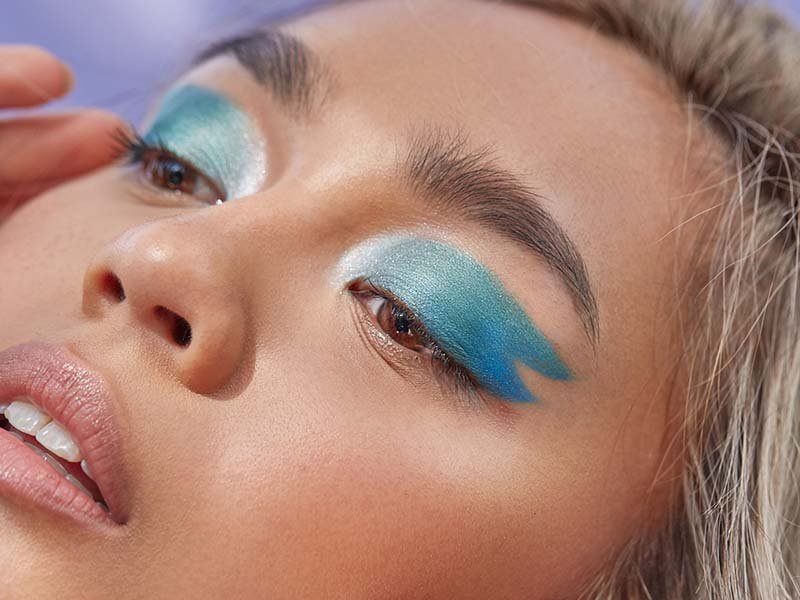 person wearing blue shimmering eyeshadow