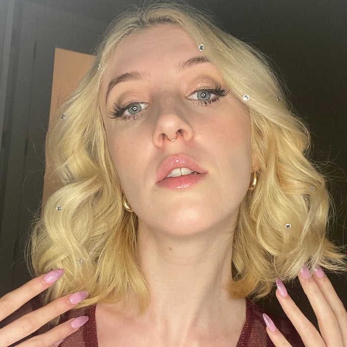 person wearing rhinestone stickers in blonde hair