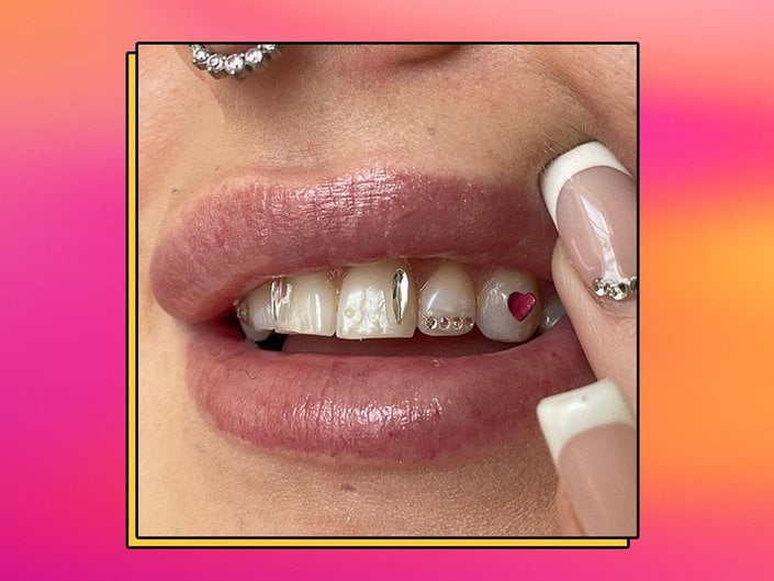 person showcasing tooth gem designs