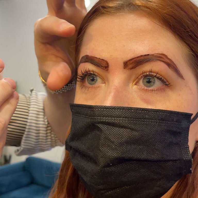 person getting their eyebrows tinted