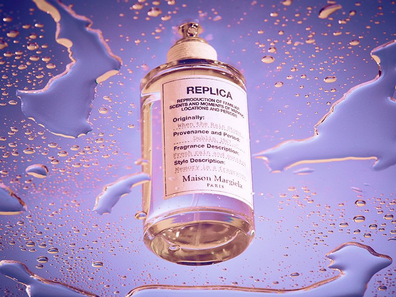 Maison Margiela REPLICA When the Rain Stops perfume on purple background with water droplets