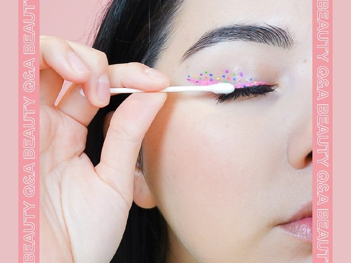 person removing mascara with q-tip
