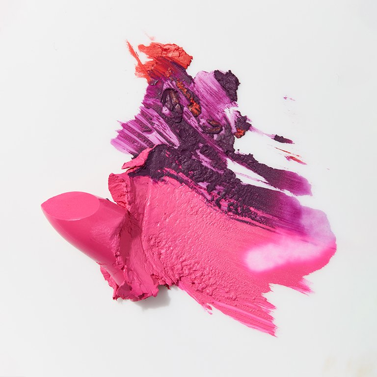  Image of pink, purple and red lipstick smeared on a white background