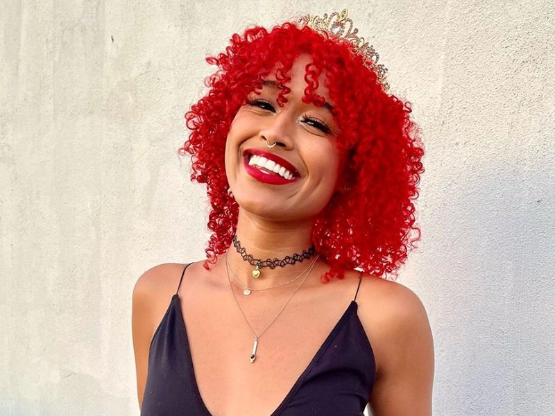 person smiling with red curly hair