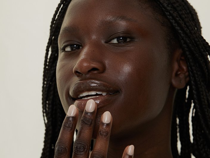Image of woman applying lip balm