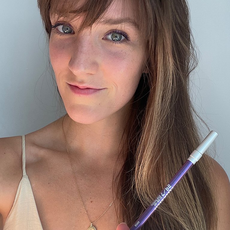 Image of a woman holding the Urban Decay 24/7 Glide-On Waterproof Eye Pencil in Viper