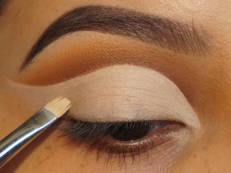 Image of a person applying concealer as eyeshadow primer to their eyelids