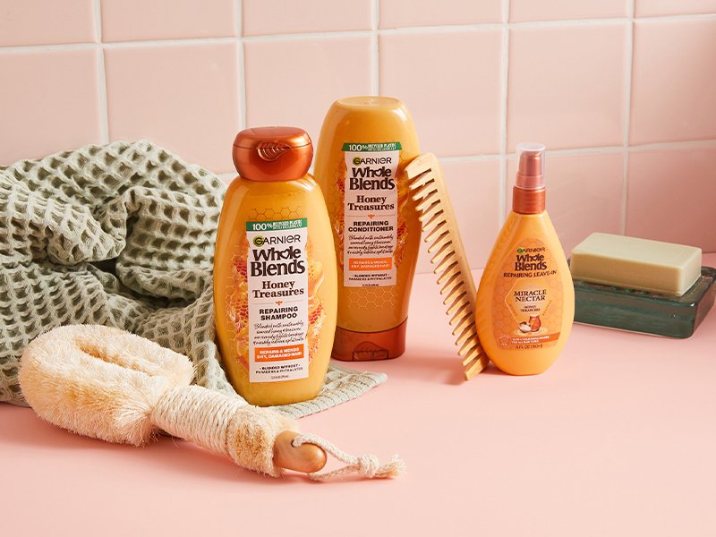 Image of Garnier Whole Blends Honey Treasures collection in a pink bathroom