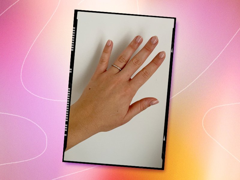 Person's hand with pink nude manicure