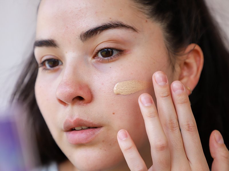 Person swatching foundation on their cheek