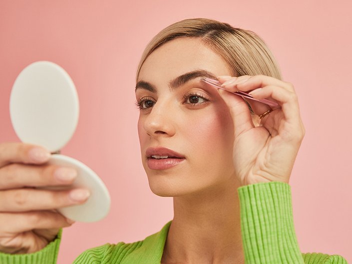 person plucking eyebrows