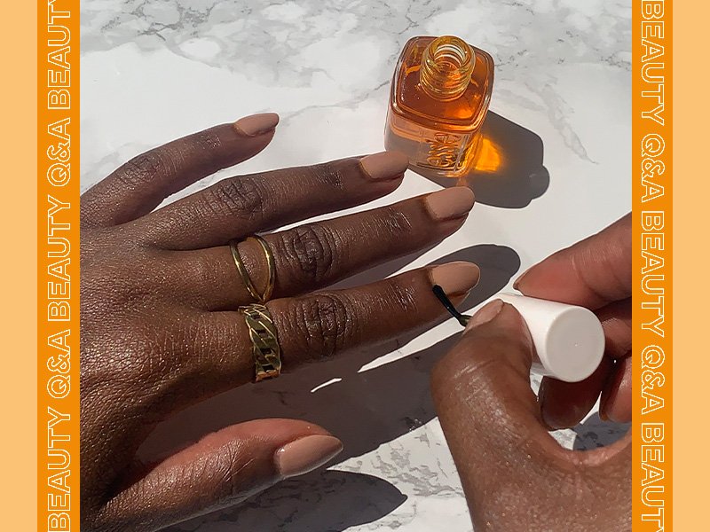 Person applying Essie Apricot Cuticle Oil to their nails