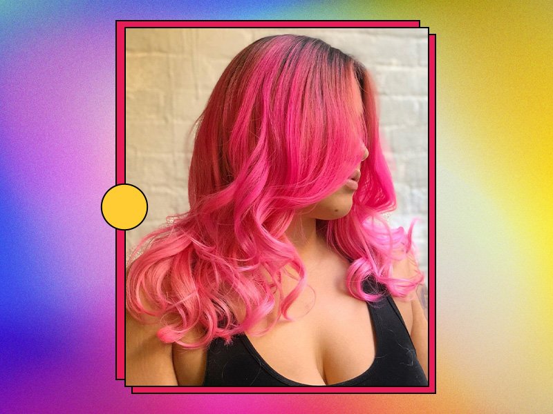 Person with pink hair on rainbow graphic background