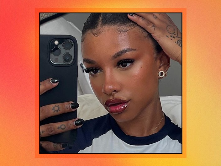 person taking a selfie in their mirror on red and orange graphic background