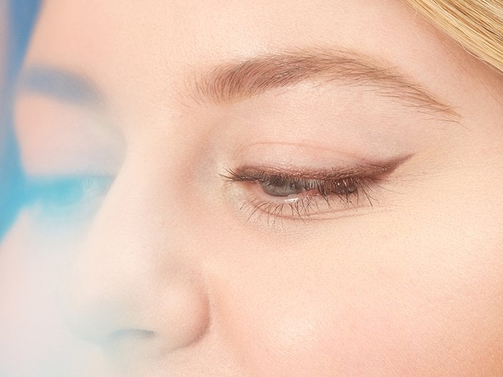 Close-up image of someone with brown eyeliner on their upper lash line