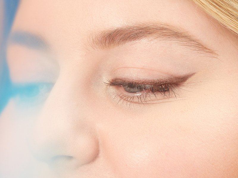 Close-up of blonde person's brown eyeliner