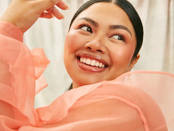 person smiling with blush on