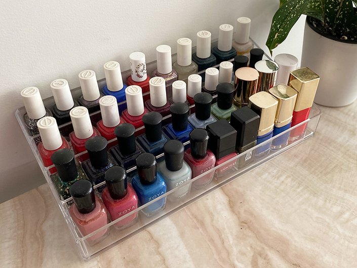 Nail polish bottles in a clear storage container