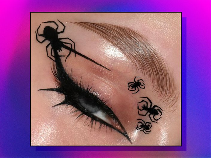 close-up of person's eye wearing spider makeup