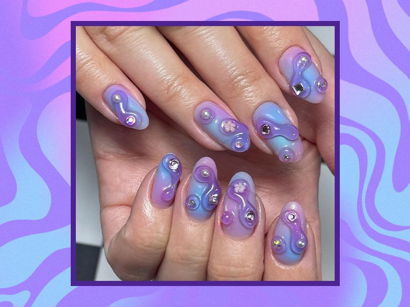 A picture of purple blobby nails on a blue and purple swirly background