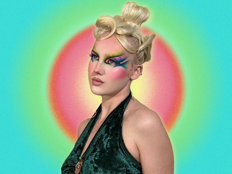 Person with blonde hair in an updo and colorful makeup looking to the side of the camera, collaged on a pink, green and blue aura background