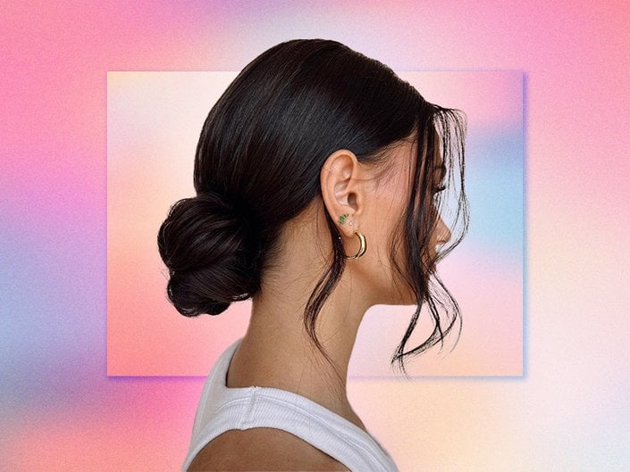 Picture of a person in profile with dark hair in a bun, on a multicolored graphic background