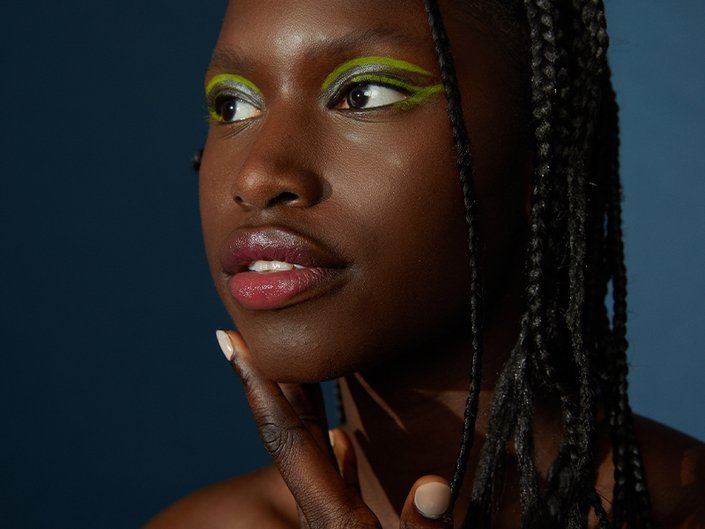 Picture of a model in 3/4 profile with pink lipstick on