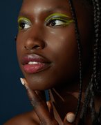 Picture of a model in 3/4 profile with pink lipstick on