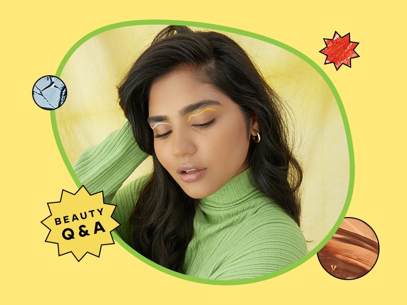 Image of a person with their hand in their dark brunette hair, looking down, wearing a green sweater and floating eyeliner in shades of white and yellow. The background is yellow with a “Beauty Q&A” graphic.