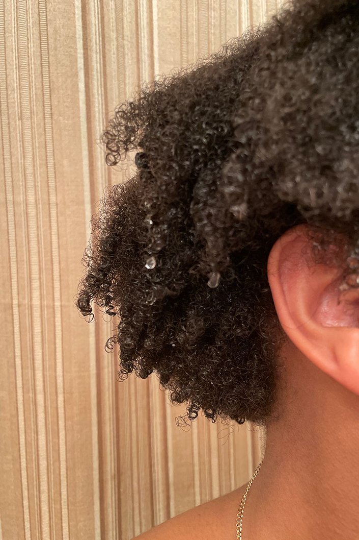 a close up of kat's natural hair after washing with the redken soft curls shampoo and conditioner